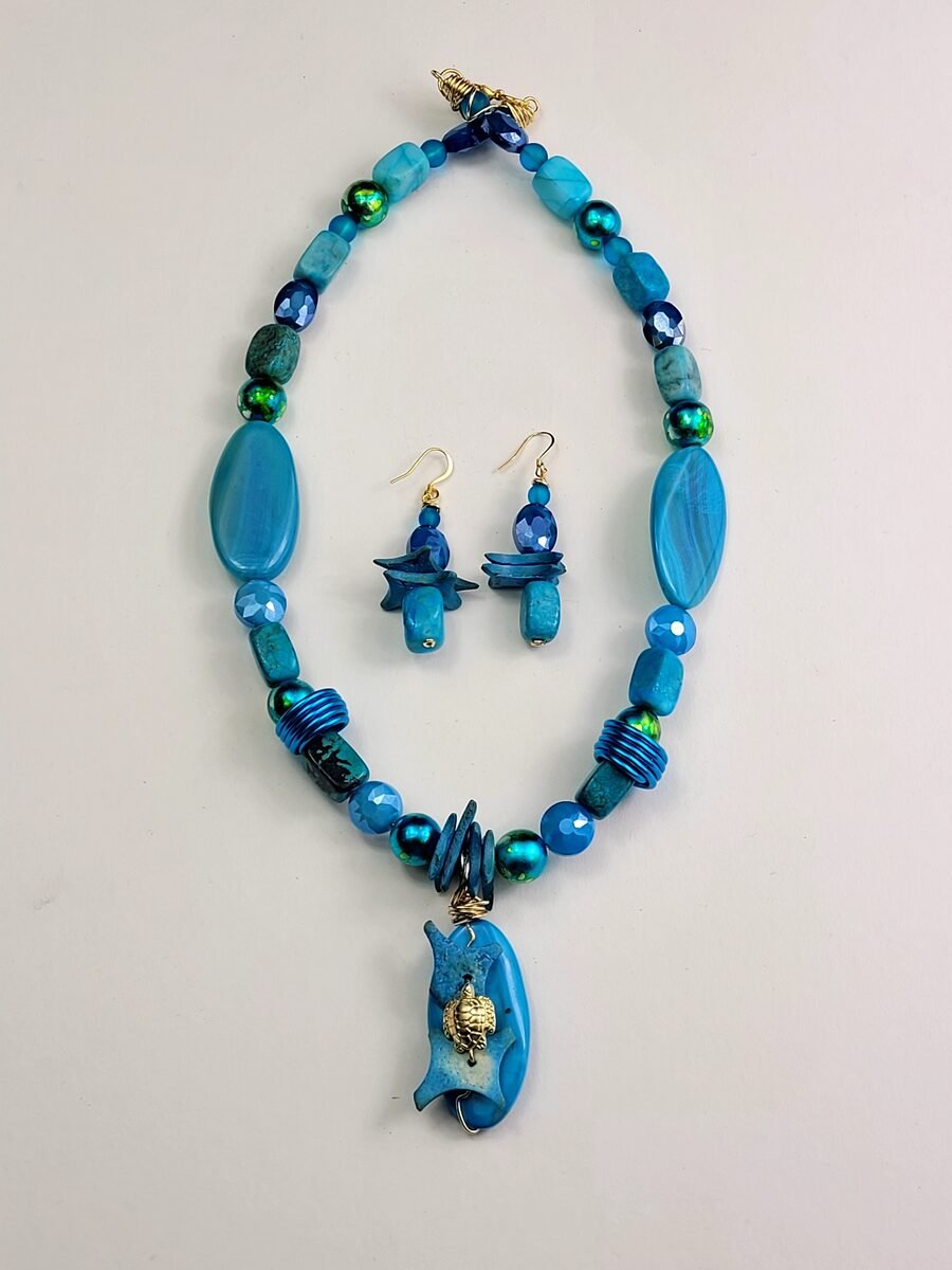 Blue beaded necklace with a turtle pendant.