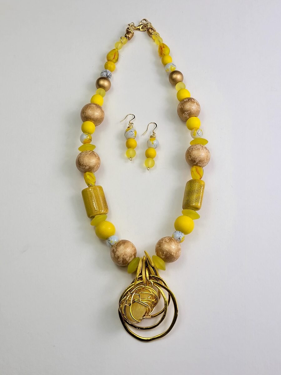 Yellow beaded necklace with gold hoop accents.