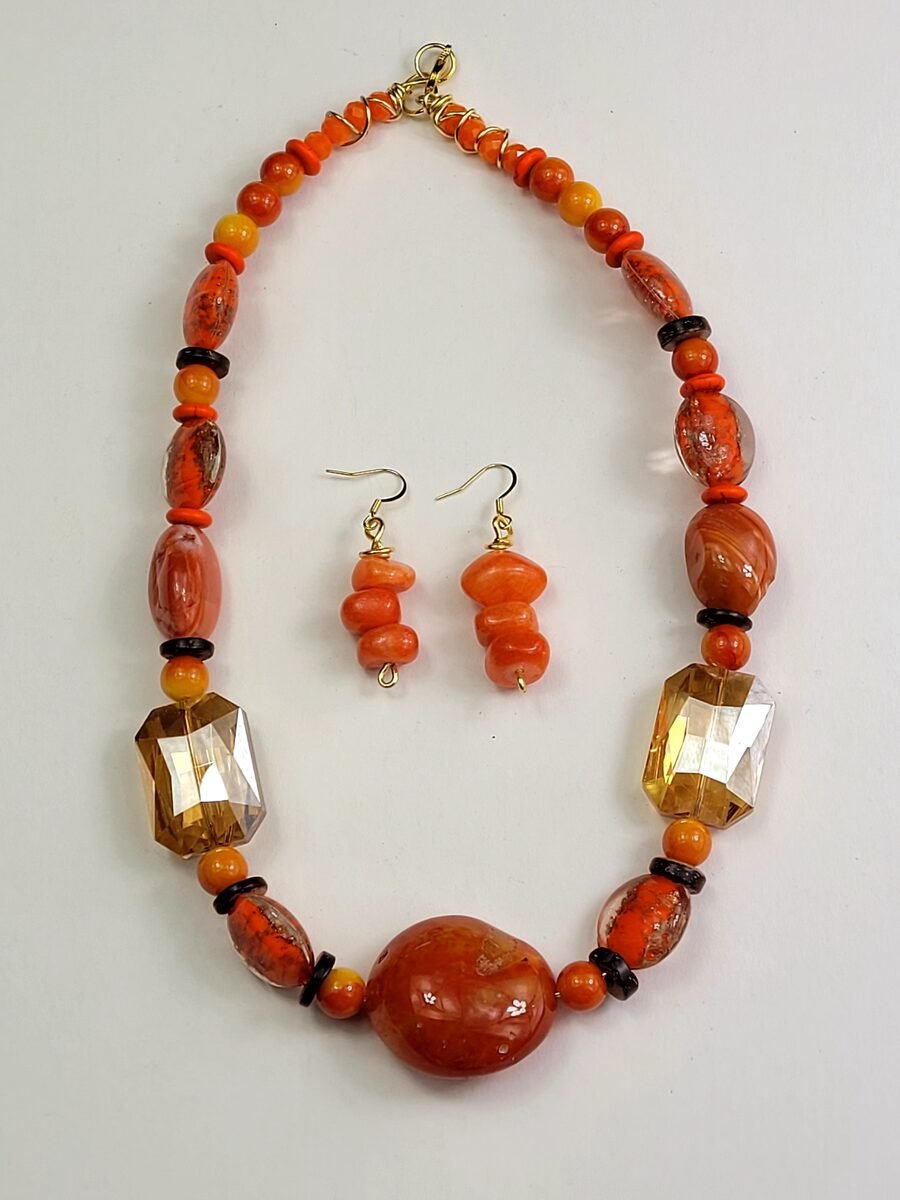 Orange beaded necklace with amber crystal accents.