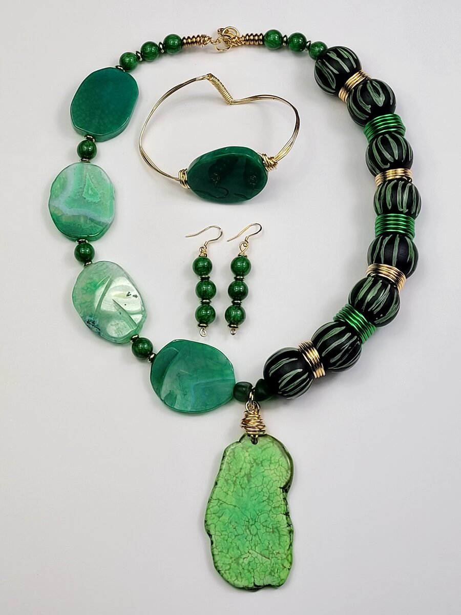Emerald necklace with polished green agate slabs and carved ribbed jade beads.