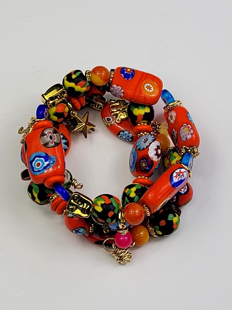 Stack of orange millefiori beaded bracelets.