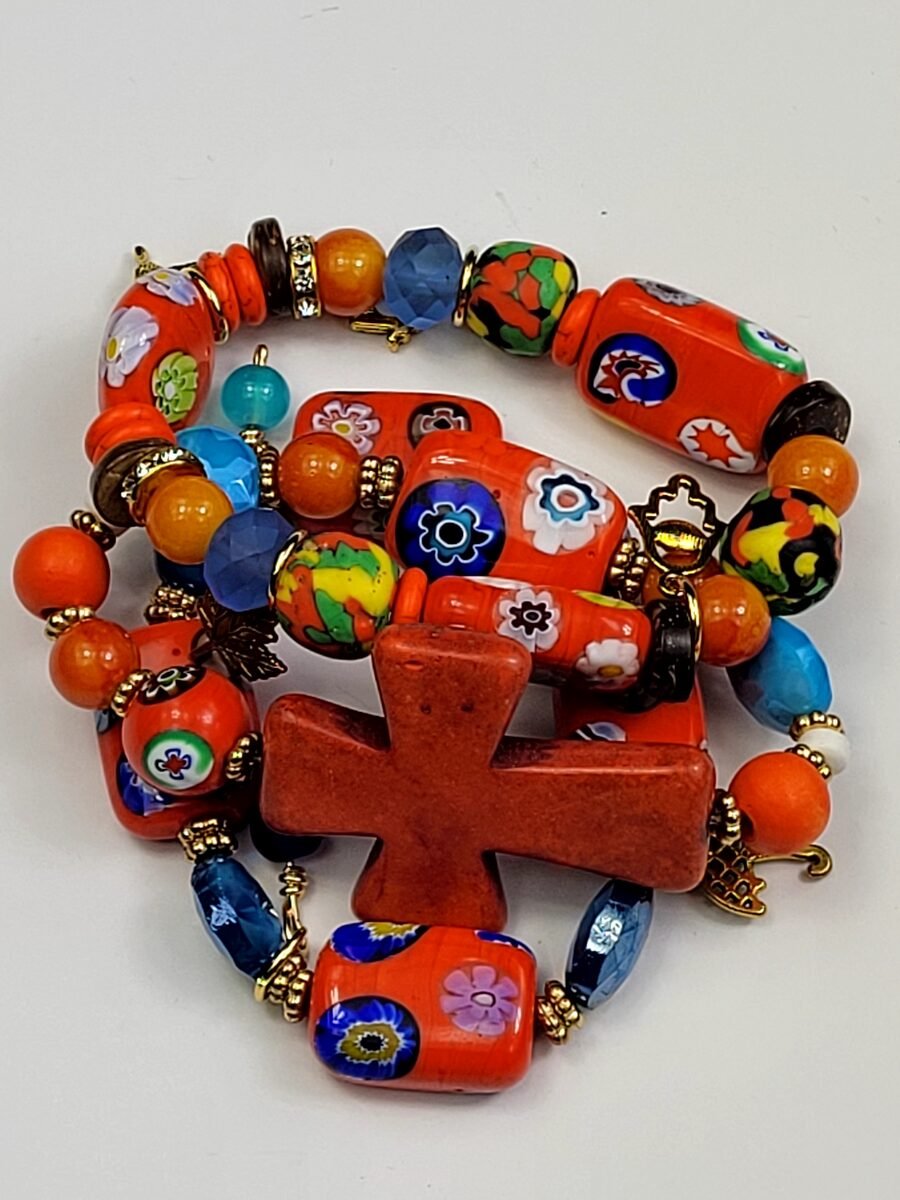 Orange millefiori beaded bracelet with cross charm.